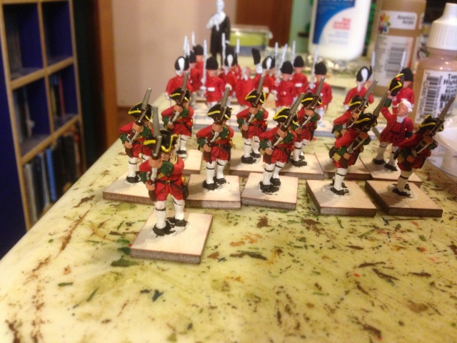 An overall glimpse at a portion (the tidy corner) of my painting table.  The nearly finished Hibernia Regiment fusiliers, the barely started Grenadiers and the 54mm Abraham Lincoln in the background. 